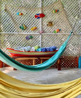 a hammock in a room with a wall at Casita Caribe en reserva natural, playa privada, kayaks, wifi, aire acondicionado in San Onofre