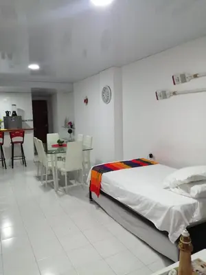 a bedroom with a bed and a table and chairs at Acogedor apartamento en Cartagena in Cartagena de Indias