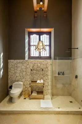 a bathroom with a toilet and a window at Privado Designer Boutique Hotel in Cartagena de Indias