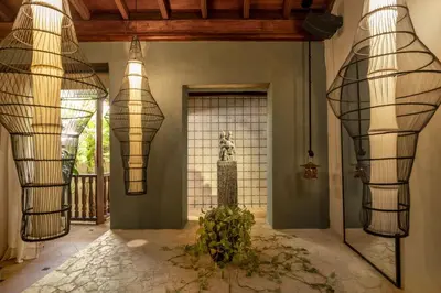 a hallway with two large metal sculptures on the wall at Privado Designer Boutique Hotel in Cartagena de Indias