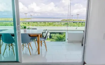 a dining room with a table and a view of the ocean at apartamento 1 alcoba morros 922 rnt 132107 in Cartagena de Indias