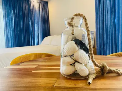 a glass jar with seashells in it on a table at ✰ Beach Loft ✰ Condominio de lujo ✰ in Cartagena de Indias