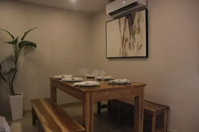 a dining room table with plates and glasses on it at Casa Badillo 3 4br LUXURY ROOFTOP oldcity AC jacuzzi hottub wifi in Cartagena de Indias
