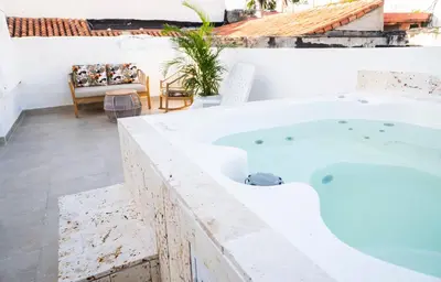 a hot tub on the roof of a house at Casa Quero 915 4BR House Old City rooftop jacuzzi AC full Wifi in Cartagena de Indias