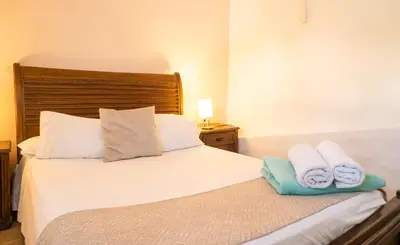 a bedroom with a bed with towels on it at Casa Quero 915 4BR House Old City rooftop jacuzzi AC full Wifi in Cartagena de Indias