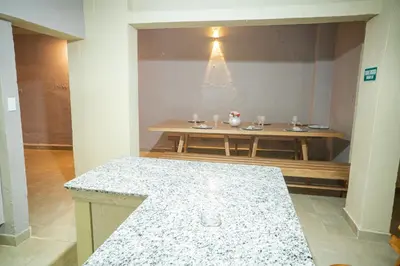 a room with a table and a counter with at Casa Badillo 2 OLD CITY CRAZY LOCATION 4br jacuzzi wifi Ac hottub in Cartagena de Indias