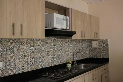 a kitchen with a sink and a microwave at Casa Moneda 1 5BR amazing house picusi AC old city in Cartagena de Indias