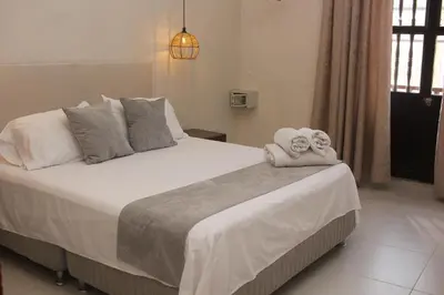 a bedroom with a bed with towels on it at Casa Moneda 1 5BR amazing house picusi AC old city in Cartagena de Indias