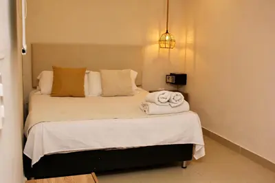 a bedroom with a bed with towels on it at Casa Moneda 1 5BR amazing house picusi AC old city in Cartagena de Indias