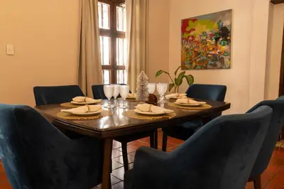 a dining room with a table and four chairs at Casa Quero 954 COZY HOUSE ROOFTOP POOL AC OLD CITY in Cartagena de Indias