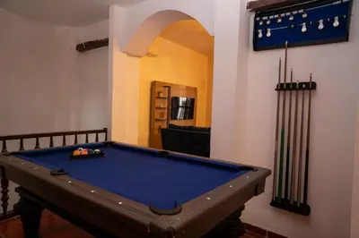 a pool table in the middle of a room at Casa Quero 954 COZY HOUSE ROOFTOP POOL AC OLD CITY in Cartagena de Indias