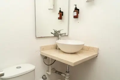 a bathroom with a sink and a toilet at Casa Quero 954 COZY HOUSE ROOFTOP POOL AC OLD CITY in Cartagena de Indias