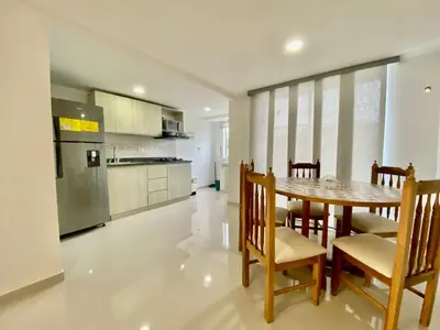 a kitchen and dining room with a table and chairs at Apartasol Amoblado Primer Piso Coveñas in Coveñas