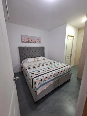 a bedroom with a bed in a white room at Hermoso apartamento para tu disfrute y bienestar in Cartagena de Indias