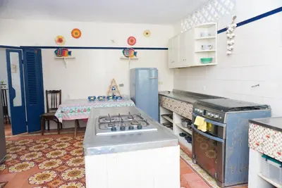 a kitchen with a stove and a table in it at Casa Antigua in San Silvestre