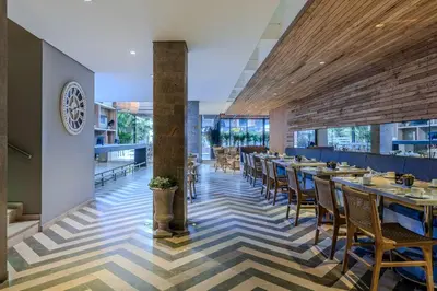 a restaurant with tables and chairs in a room at Oz Hotel Cartagena in Cartagena de Indias