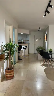 a large living room with a table and chairs at Cabrero Beach 1111 in Cartagena de Indias