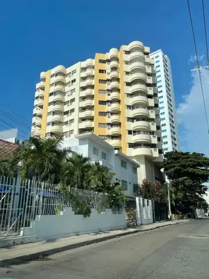 a large apartment building with a fence in front of it at Cabrero Beach 1111 in Cartagena de Indias