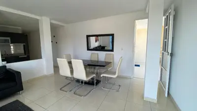 a dining room with a table and white chairs at Lindo Apartamento vacacional in Cartagena de Indias