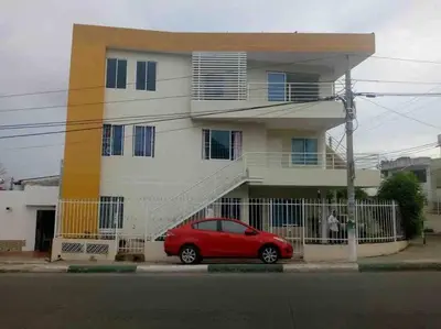 a red car parked in front of a house at Lindo Apartamento vacacional in Cartagena de Indias