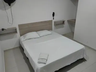 a white bed in a white room with at HOTEL MAR DEL CARIBE in Soledad