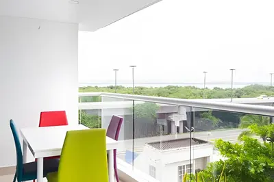 a room with a table and chairs on a balcony at 1 Dormitorio con salida directa playa de Morros in Cartagena de Indias