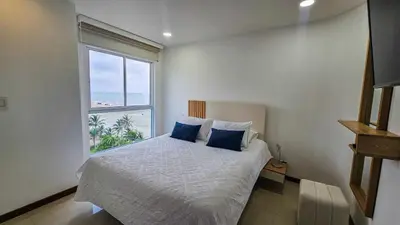 a bedroom with a bed with a large window at Luxury apartment, sector morros, vista y salida al mar edificio Sunshine in Cartagena de Indias