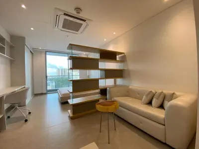 a living room with a couch and a desk at Apartaestudio Amoblado - Distrito90 in Barranquilla