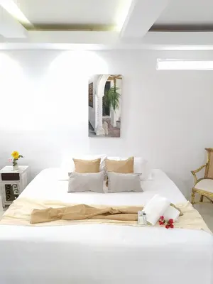 a white bedroom with a large white bed at Casa Ego in Cartagena de Indias