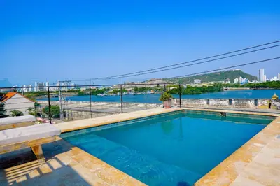 a swimming pool with a view of the water at Del Mar Guest House in Cartagena de Indias