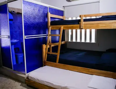 a bunk bed room with two bunk beds and a ladder at Cabaña Perla Azul in Coveñas