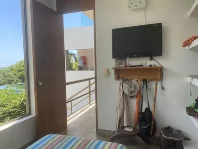 a bedroom with a flat screen tv on a wall at Nuestra Casa in Tubará