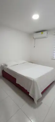 a bed in a room with a white wall at Casa Para 3 a 12 personas in Cartagena de Indias