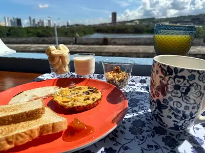 a plate of bread on a table with a cup of coffee at Casa Cielo Cartagena in Cartagena de Indias