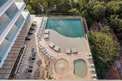 an aerial view of a hotel swimming pool with lounge chairs at Hilton Santa Marta in Santa Marta