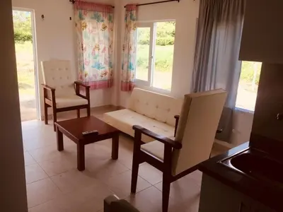a living room with a couch and a table and chairs at Cabañas Paulamar-Apto 3- Tolu in La Gloria