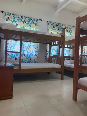a room with three bunk beds in a room at Cabañas Paulamar-Apto 3- Tolu in La Gloria