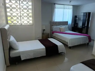 a bedroom with two beds and a window at buenavista class in Barranquilla
