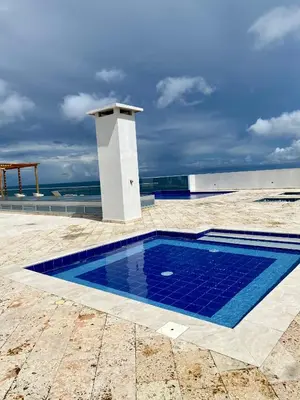 a swimming pool with blue tiles on the ground at Ocean Drive Beach House - Cartagena in Cartagena de Indias