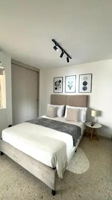a bedroom with a large bed and a ceiling fan at Cabrero Beach 1212 in Cartagena de Indias