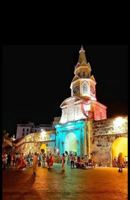 a building with a clock tower at night at Cabrero Beach 1212 in Cartagena de Indias