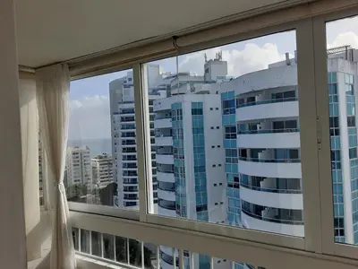 a window with a view of a large building at Oceanside 3-bedroom apartment in fun tourist area in Cartagena de Indias