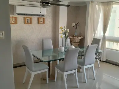 a dining room with a glass table and chairs at Oceanside 3-bedroom apartment in fun tourist area in Cartagena de Indias