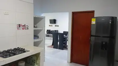 a kitchen with a stainless steel refrigerator and a stove at Cabaña Rochy in Coveñas