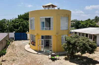 a yellow house with a tower on top of it at Casa Amarilla in Santa Veronica