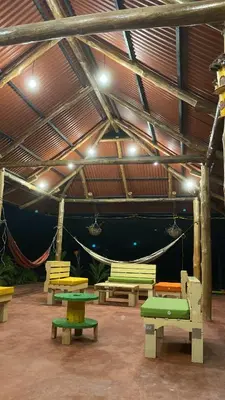 a group of picnic tables in a building with lights at Cabañas Paulamar - Apto 2 - Tolu in La Gloria