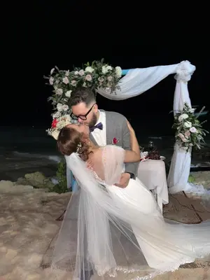 a bride and groom kissing in front of a altar at Cristal Blue Barú in Baru