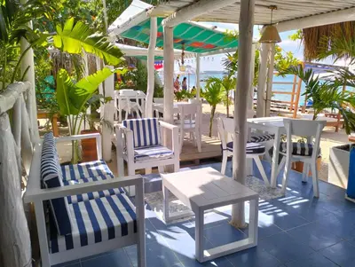 a group of chairs and tables on a patio at Cristal Blue Barú in Baru