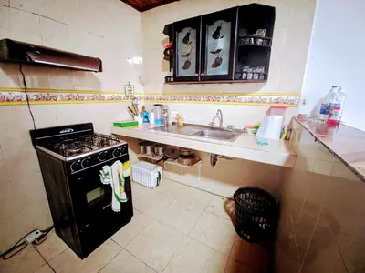a small kitchen with a stove and a sink at Casa Pupo Hostal in Cartagena de Indias