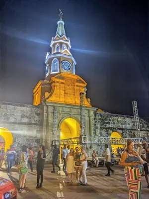 a group of people standing in front of a building with a clock tower at Casa Pupo Hostal in Cartagena de Indias